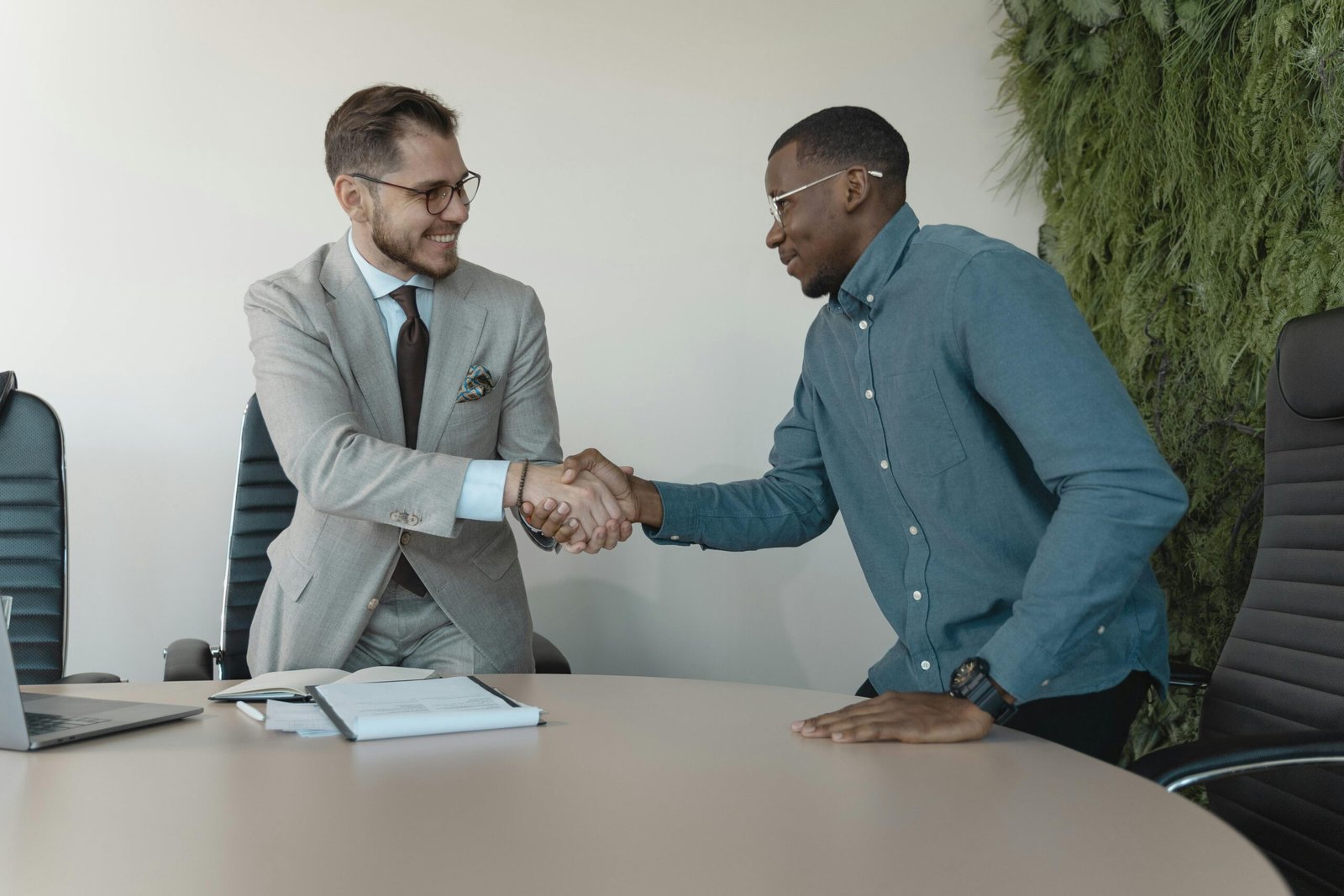 Image of a corporate professional shaking a client's hand.